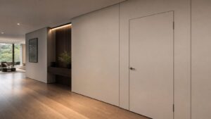 A refined modern hallway with a flush-mount fire-rated door integrated into clean wall panels.