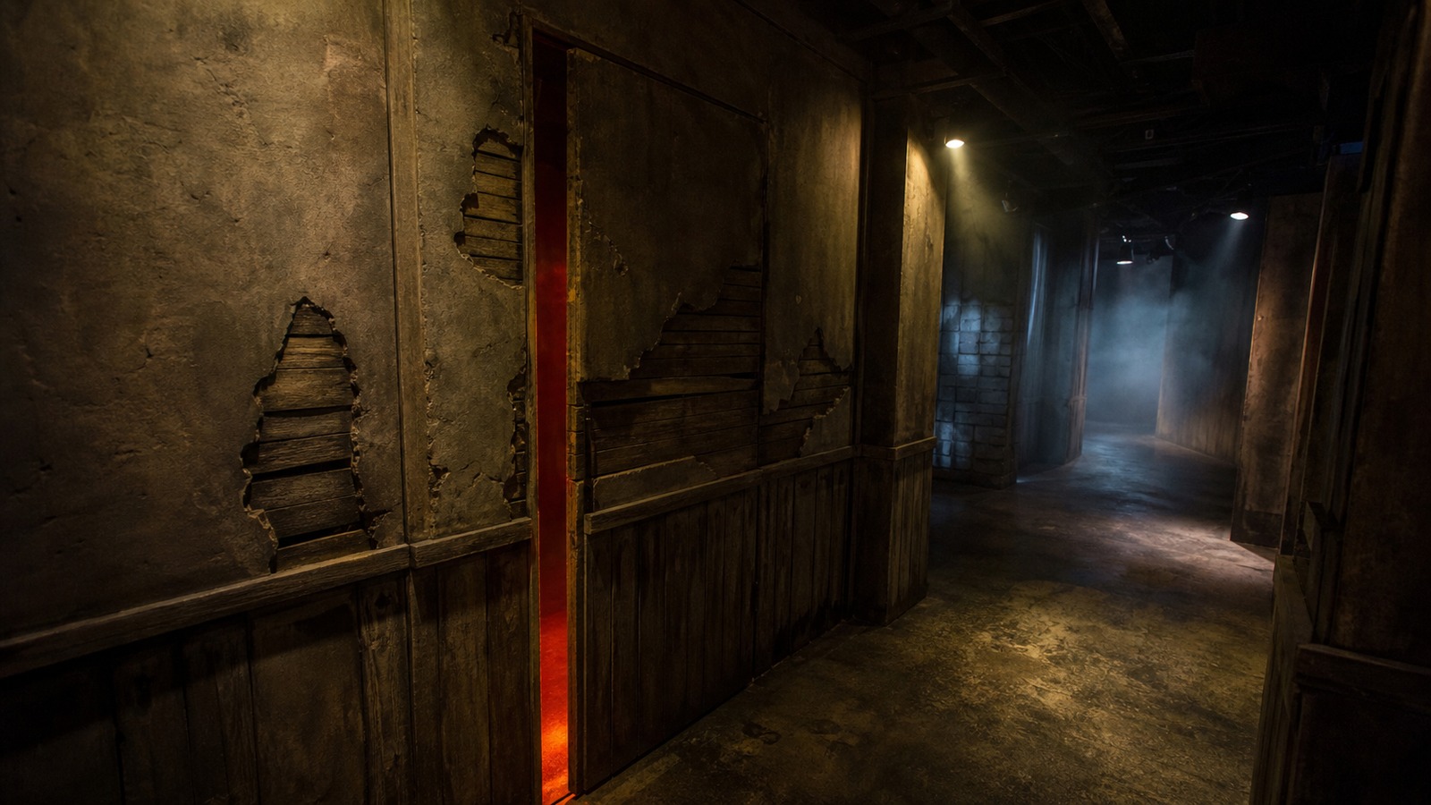A realistic editorial image of a haunted attraction hallway with a concealed scare door blended into distressed wall panels.